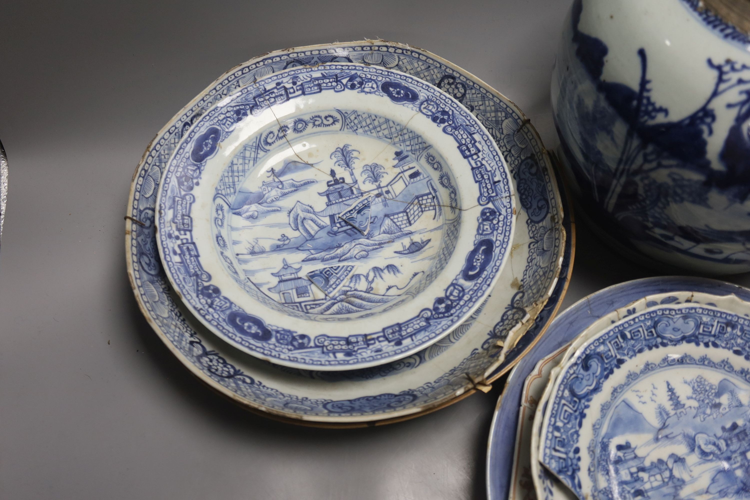 A group of 18th century Chinese export blue and white dishes, plates and a jar, the jar 21.5cm high